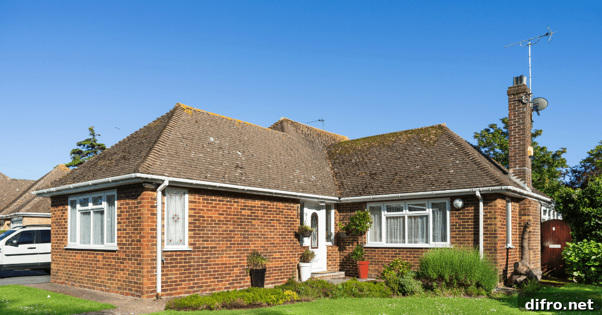 Red brick Bungalow house with white window frames.