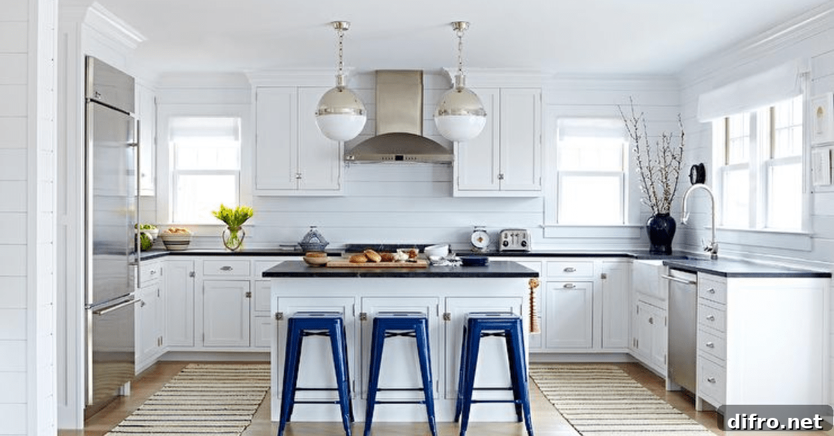 The kitchen of a Bungalow house, showcasing a modern renovated white kitchen.