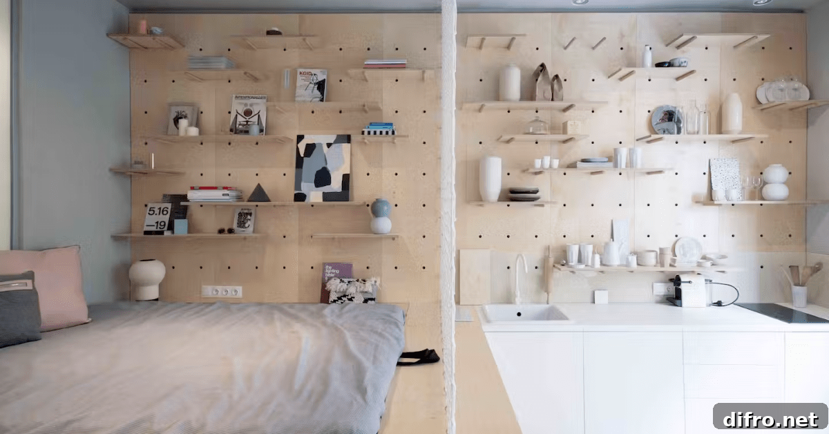 Studio apartment with pegboard and shelves storage on wall.