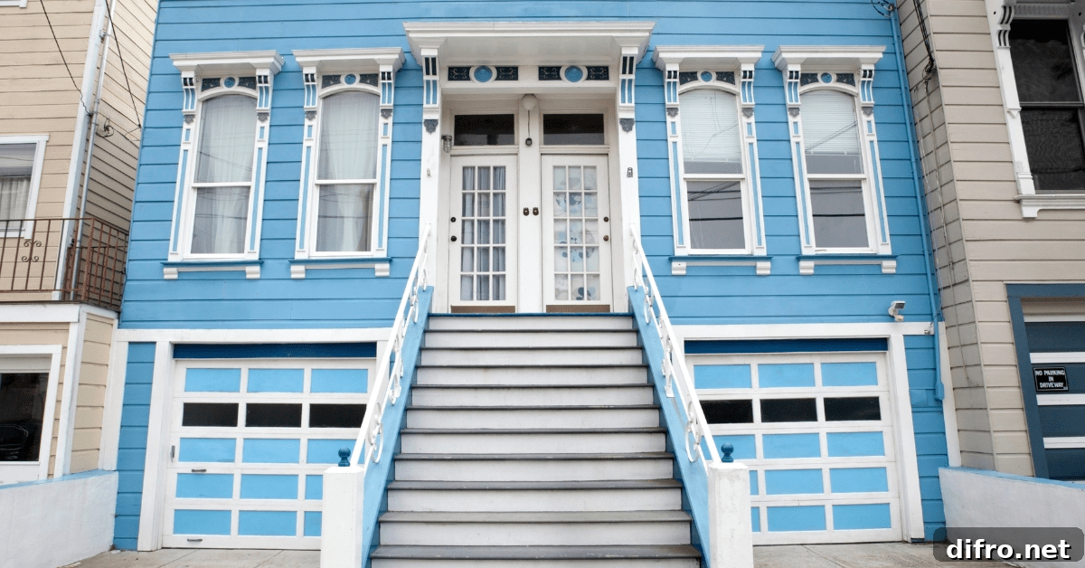 Exterior of a blue duplex with white doors.