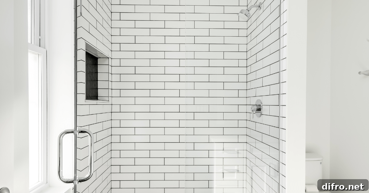 White subway tile shower with stainless steel fixtures.