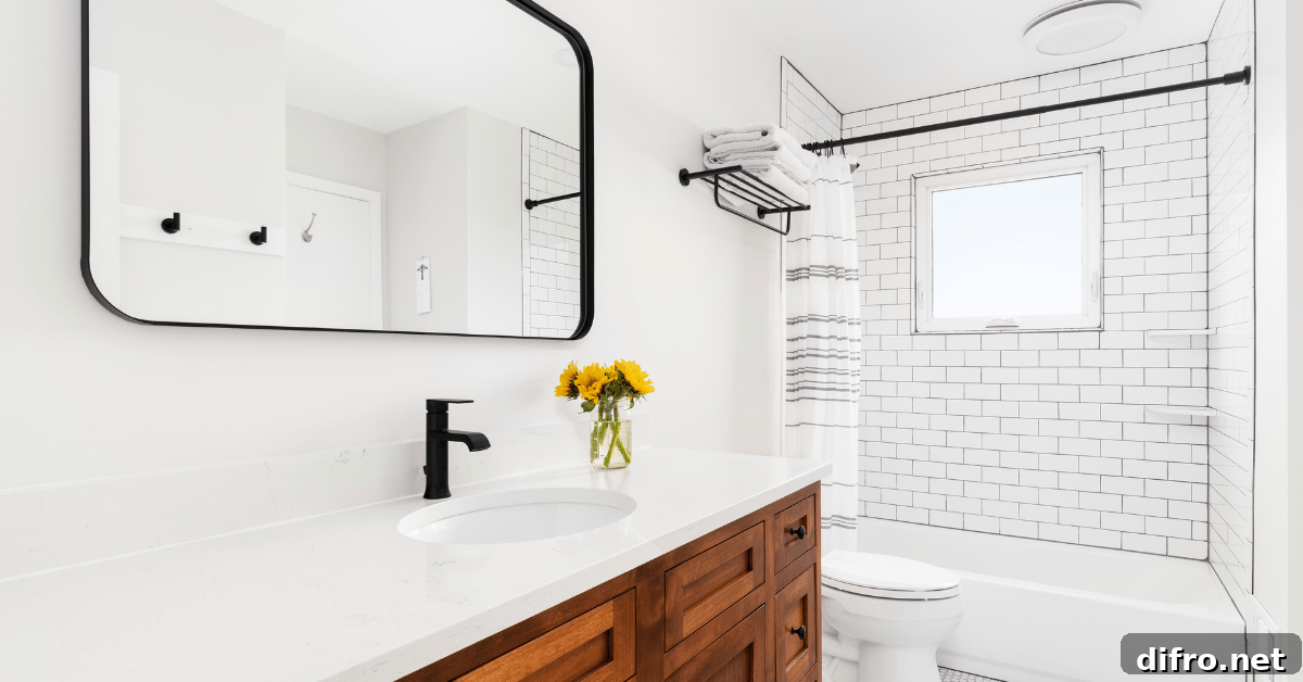 White bathroom with wooden vanity and white subway tile shower.