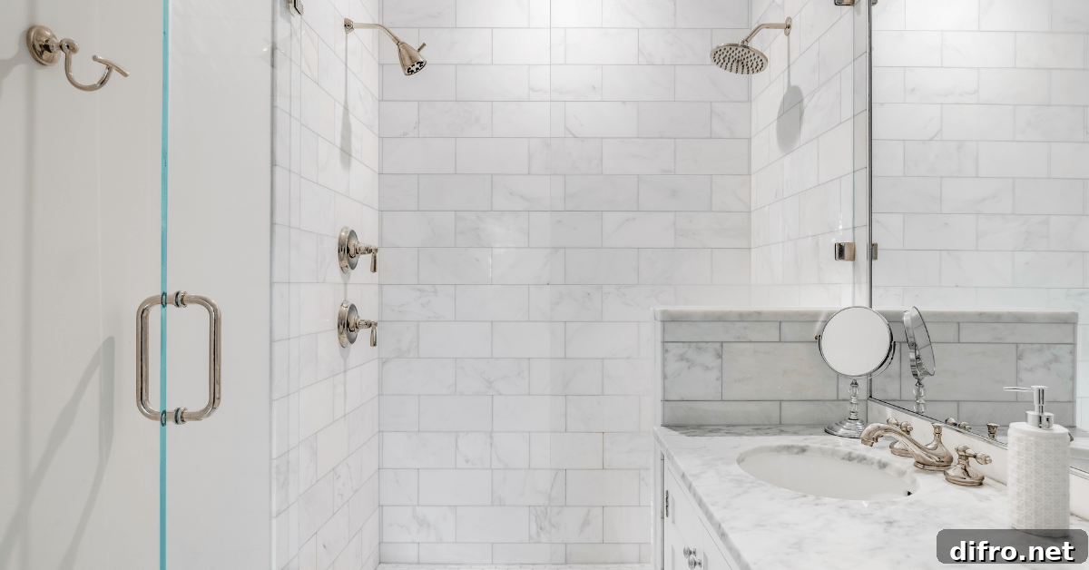 Marble white subway tile shower with metallic fixtures.