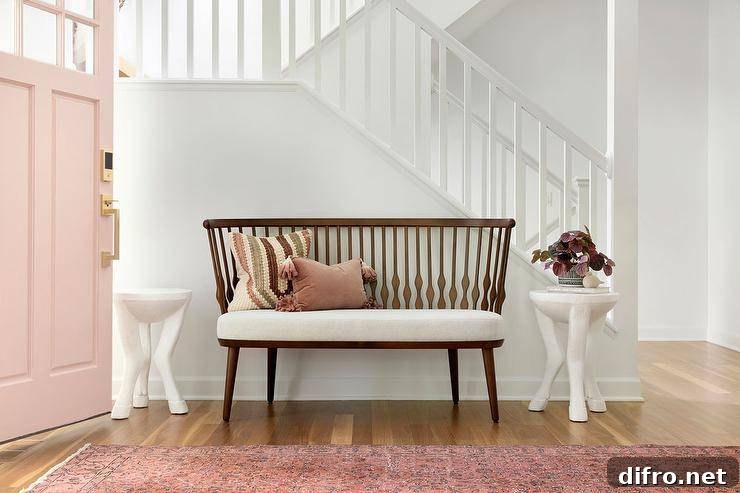 Foyer with a vintage wooden bench and a pink runner leading to a pink front door.