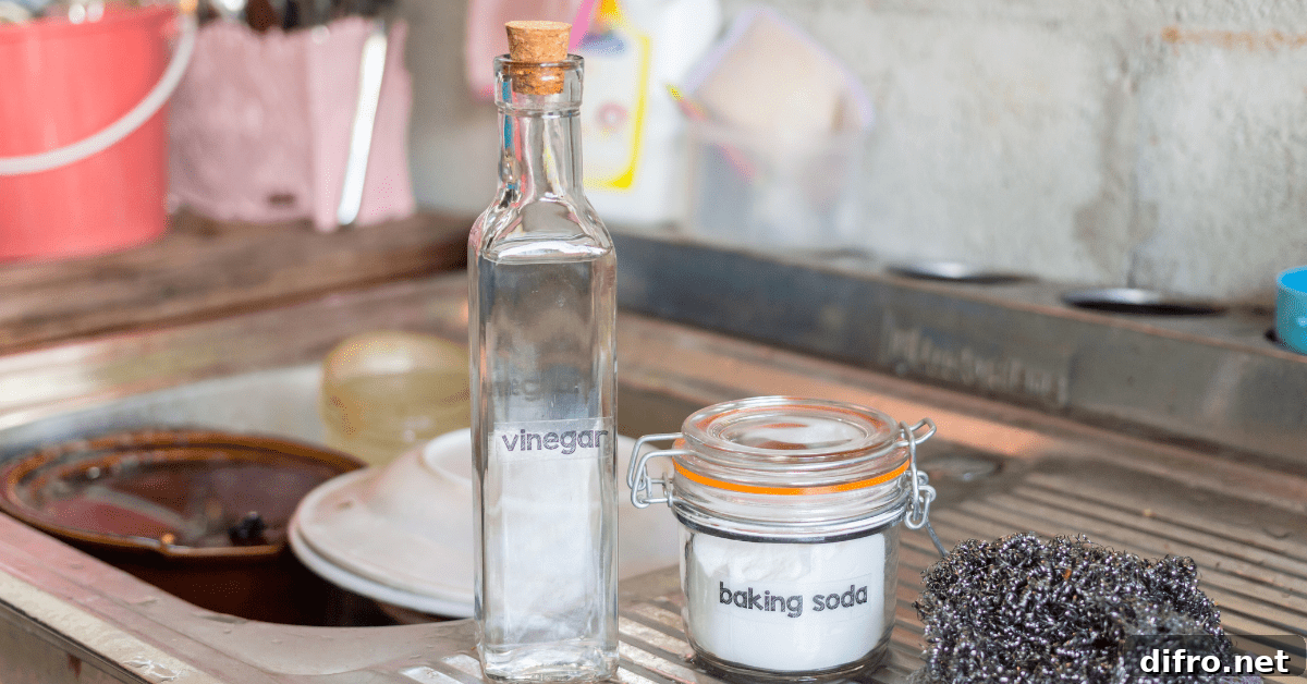 A bottle of vinegar flanked by a stainless steel sink.