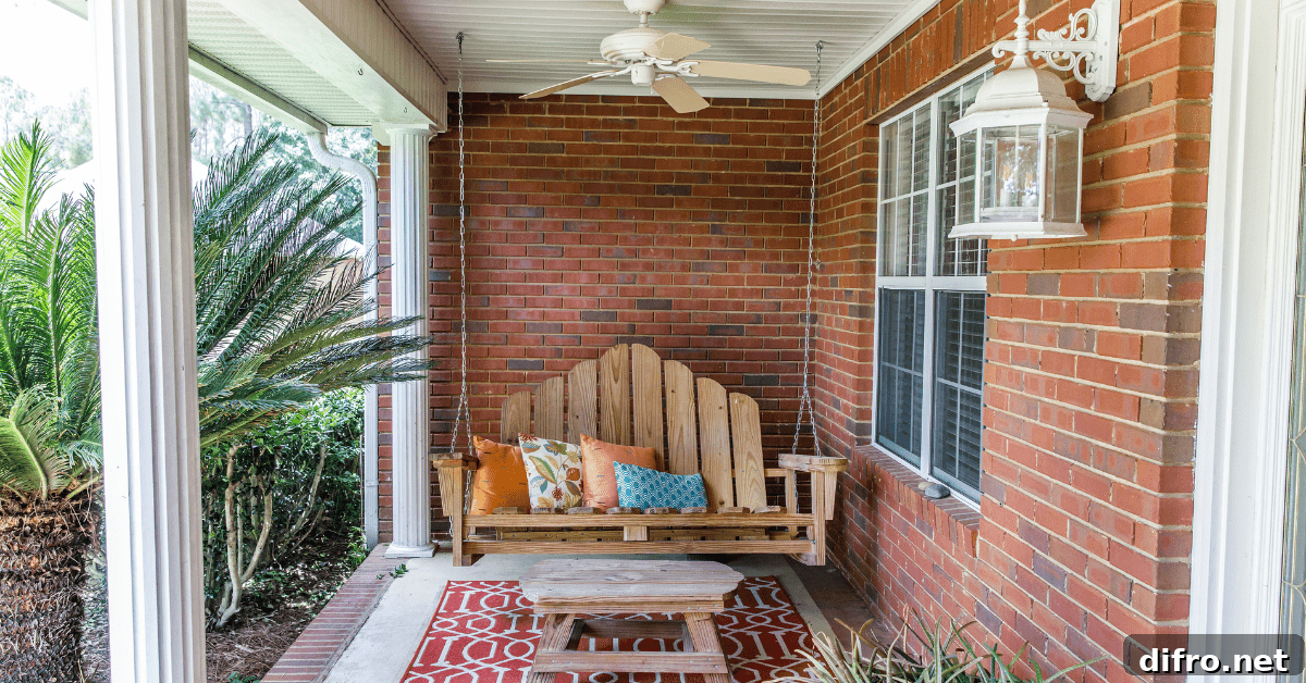 Front porch with swing bench and red rug.