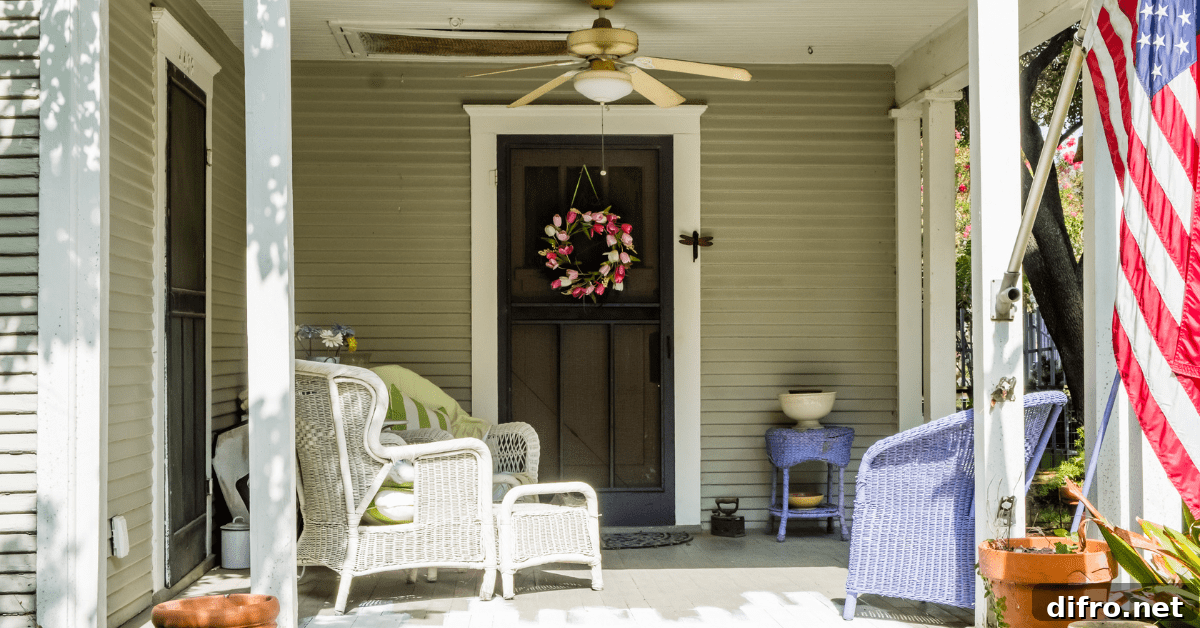 Front porch with white wicker furniture and U.S flag.