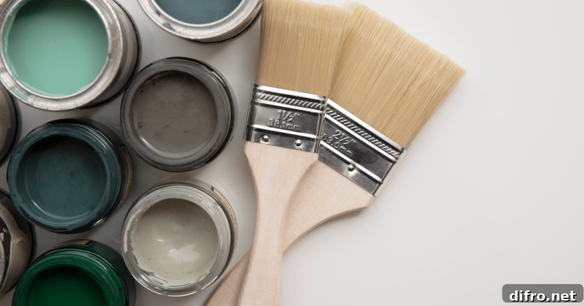 Paint cans and a brush on white background.