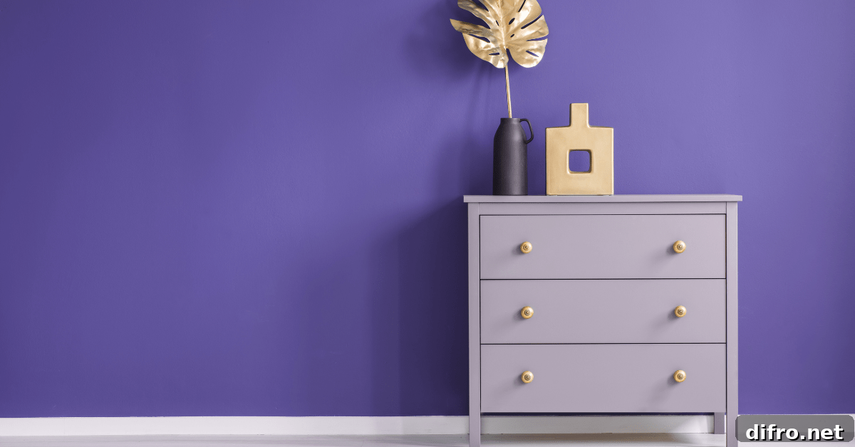 Purple painted dresser flanked by purple wall.