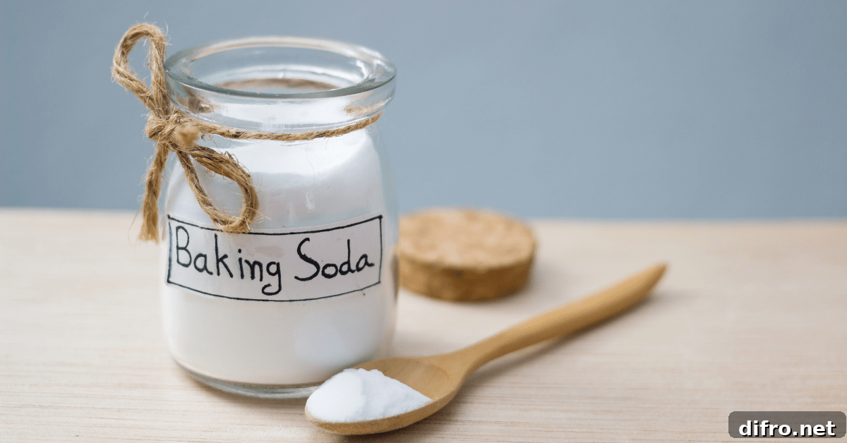 A jar with label that reads "Baking Soda" fronted by a wooden spoon.