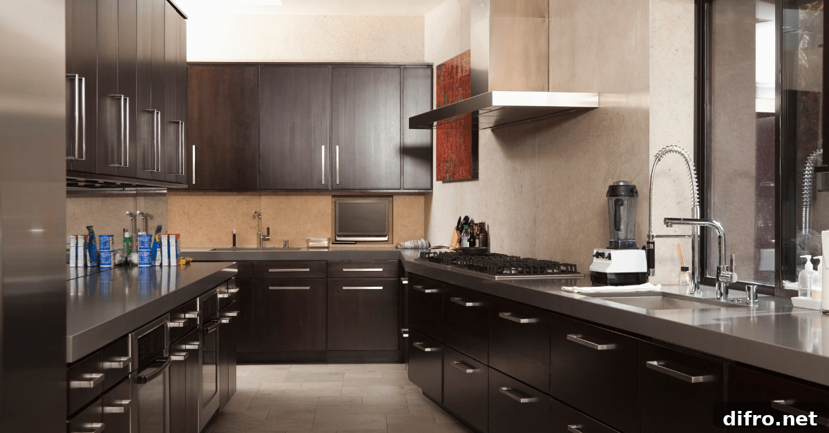 A dark galley kitchen with hardwood cabinets.