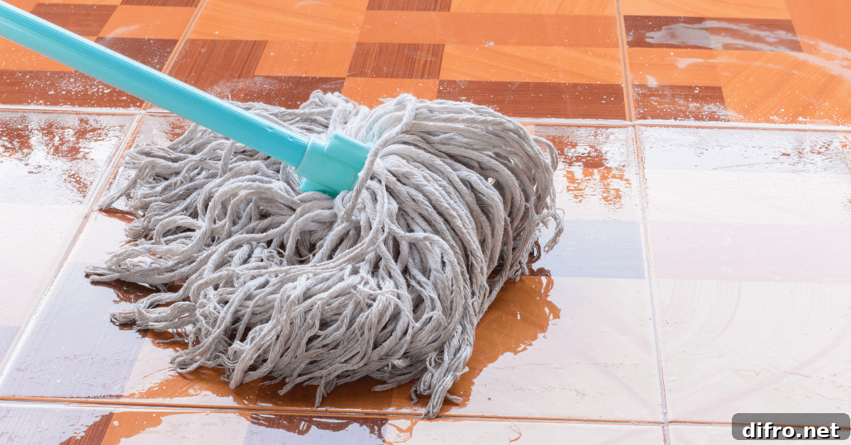 Mopping wet tile flooring.
