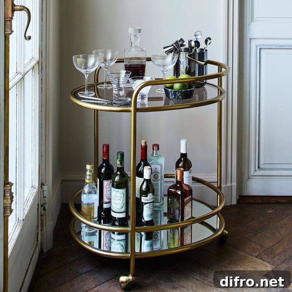 A vintage bar cart holding bottles and serving glasswear.