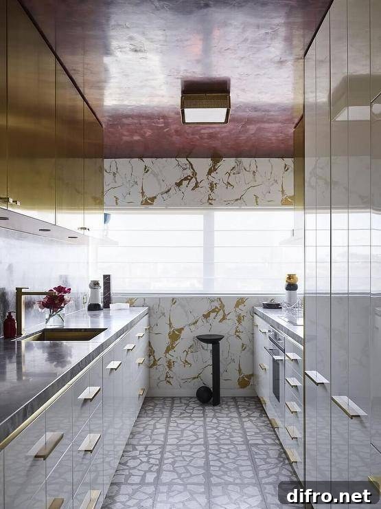 Contemporary kitchen features white and gold lacquer cabinets with black marble top and a red ceiling.