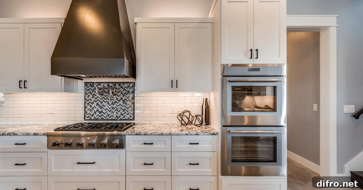 White kitchen with white tile backsplash.