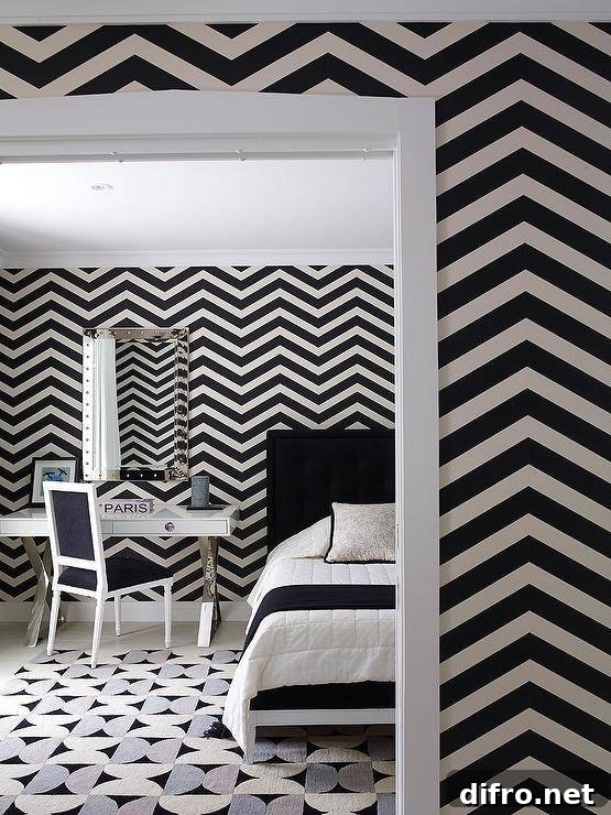 Contemporary black and white bedroom features chevron wallpaper, a black and white French bed, and a black, white and gray rug.