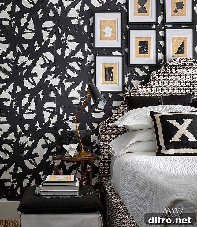 Abstract art in black frames above a houndstooth headboard and white waffle weave bedding accented with black pillows.