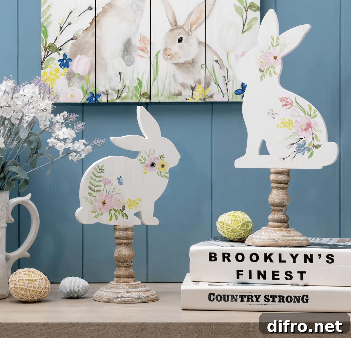 table top wood bunnies on wood pillars on top of book stacks