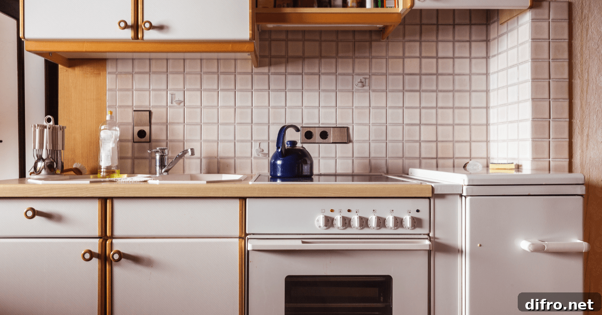 Closeup of white retro kitchen with older applicances.