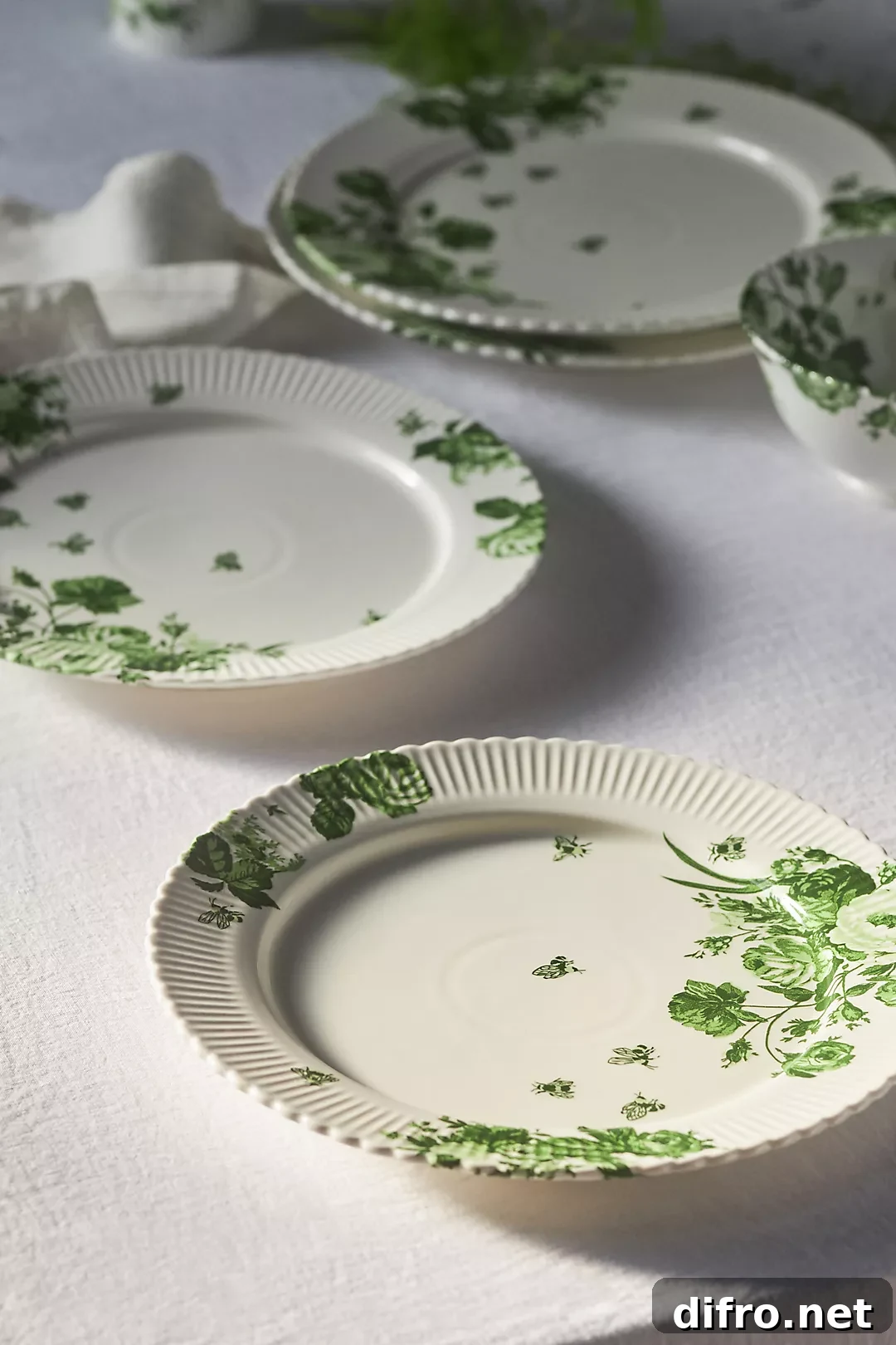white dinner plates with green leaf design