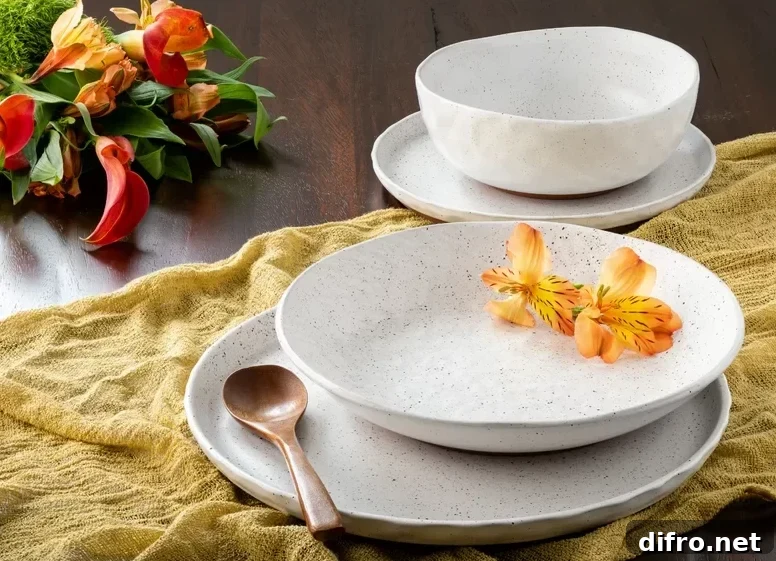 stoneware dishes on a mustard cheesecloth with flowers