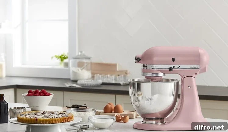 kitchen aid stand mixer pink on marble countertop with baking supplies