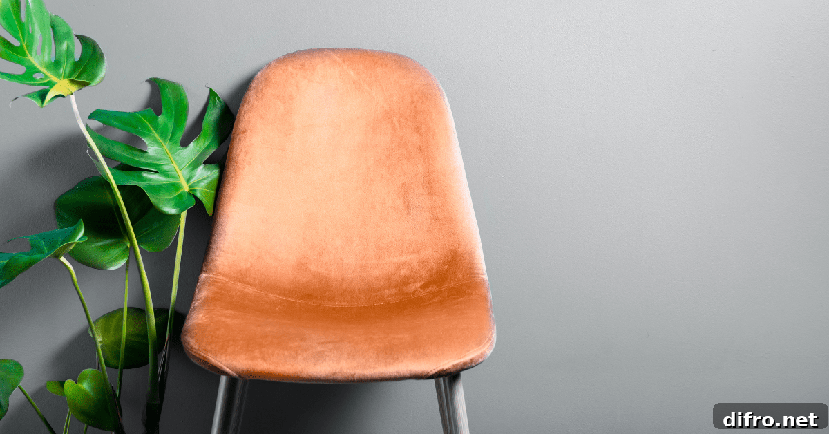 A peach colored chair and plant.