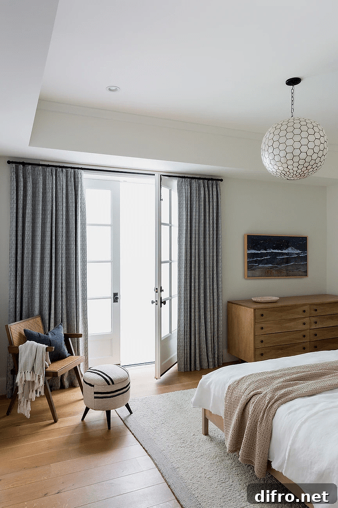 Gray curtains cover French doors behind a vintage cane chair.