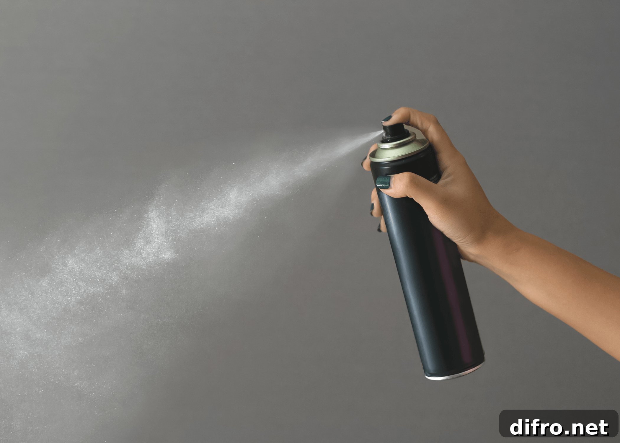 hairspray bottle being sprayed