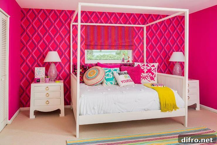 A colorful striped rug covers carpeted floors in this playful teenage girls' bedroom while positioned under a window finished with a purple and red striped roman shade framed by an accented wall covered in Pompeian wallpaper from Cole and Son's , a white canopy daybed dressed in white bedding is topped with pink and turquoise otomi pillows, an assortment of pink and accented pillows, and a mustard yellow throw. Flanking the bed are two Bungalow 5 Jacqui 3 drawer side tables topped with pink glass lamps lighting red side walls.