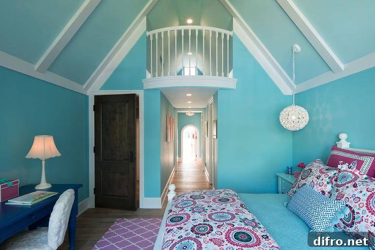 Welcoming blue and pink girl's bedroom features a white wood bed dressed in pink and blue suzani style bedding accented with a blue lumbar pillow placed in front of pink and blue suzani style shams. A white flower light hangs from a blue vaulted ceiling above a blue nightstand positioned against a blue wall. A pink trellis rug sits in front of the bed and behind a white faux fur chair placed at a blue desk.