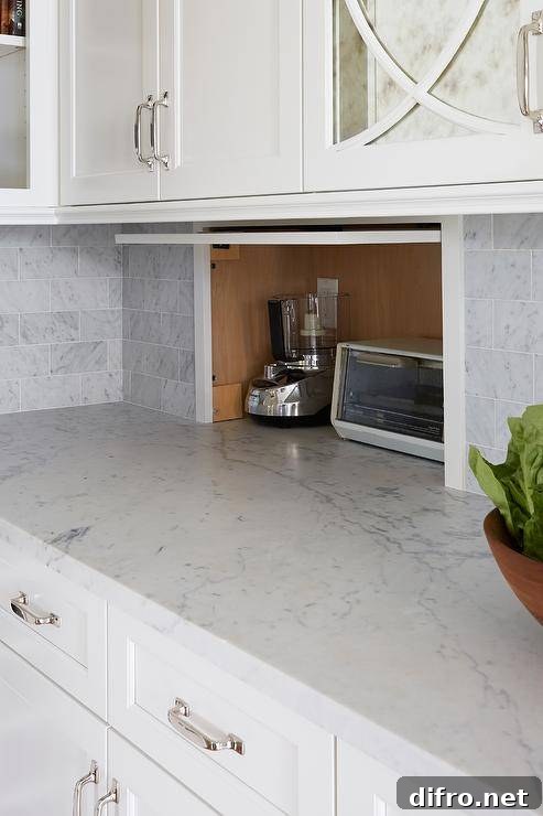 Small appliance garage cabinet stores and conceals items creating a minimalistic and clean aesthetic.