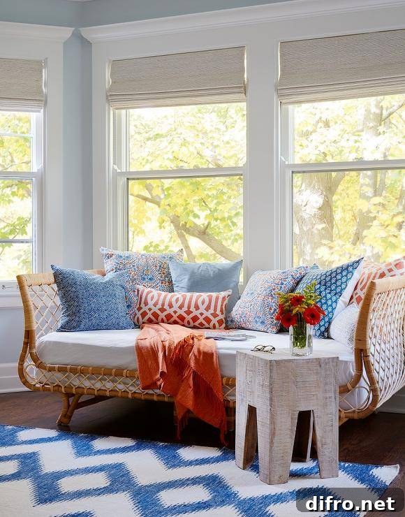 Serena & Lily Ava Daybed features a beautifully made of rattan, bringing an airy, natural beauty to the room. The original inspiration of a French sofa from the 40s adds an old-world feel decorated with multi-colored accent pills at a bay window inviting natural light for a bright and cheery ambiance.