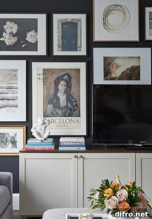 Living room features a TV atop a cream cabinet with an art wall