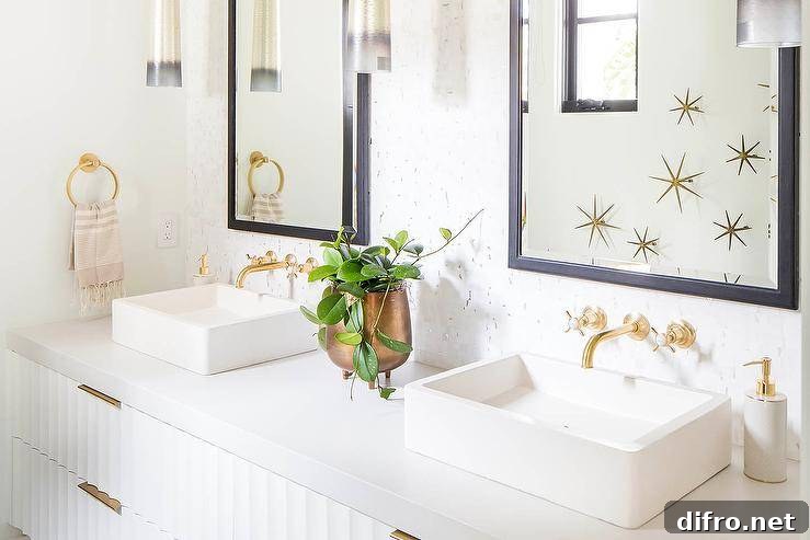 His and hers vessel sinks on a white rippled floating washstand with wall mount antique brass faucets and black beveled mirrors. Brass sunburst wall decor adds the perfect styled appeal for this transitional bathroom.