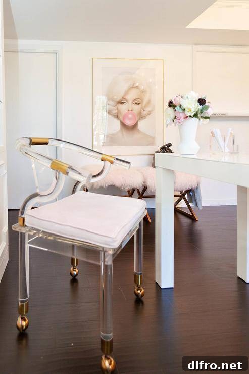 Lucite and brass chair on wheels at a white desk in a home office finished with contemporary and chic decor.