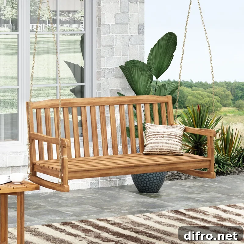 wood porch swing on patio with patio plant in background