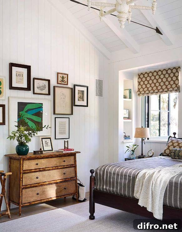 A vertical shiplap wall is accented with an art gallery hung over a bamboo dresser styled with a jade green vase in a cottagecore bedroom.