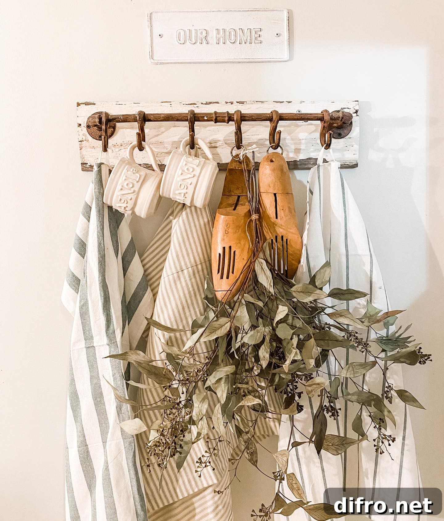 antique hook rack with tea towels and seeded eucalyptus