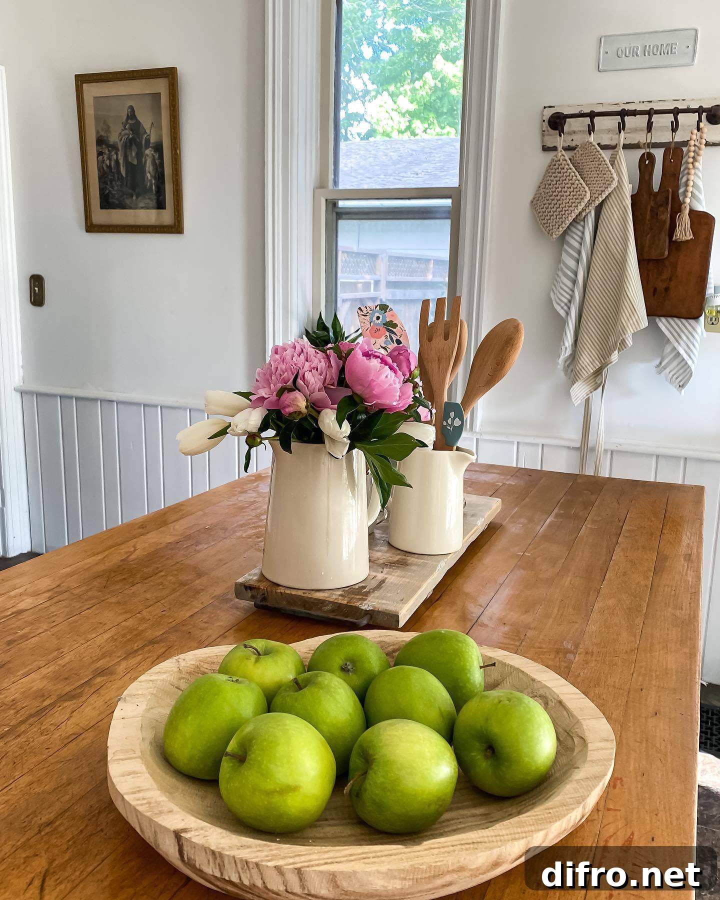 butcher block kitchen island white pitcher filled with flowers wood bowl with apples