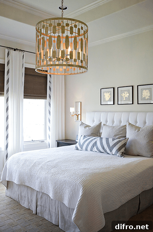 Neutral bedroom featuring a custom bolster and modern ceiling light fixture.