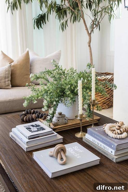 Styled coffee table with stacked books and brass candle holders.
