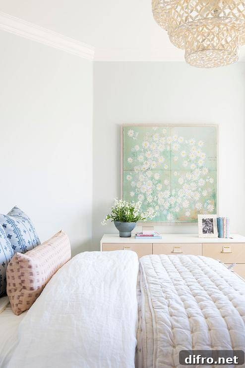 10 Creative Tapestry Hanging Ideas to Transform Any Room 6 Green tapestry wall art above a two-tone dresser in a bedroom.