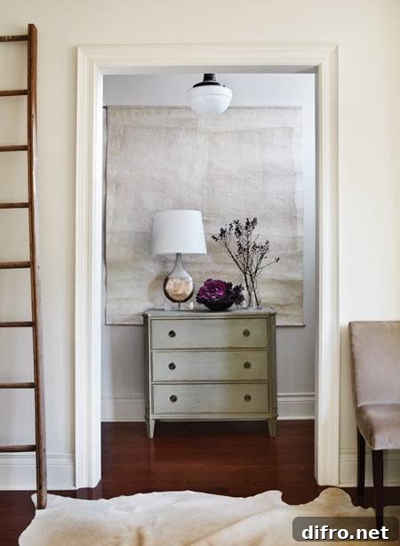 10 Creative Tapestry Hanging Ideas to Transform Any Room 10 Foyer with tapestry and gray washed chest.