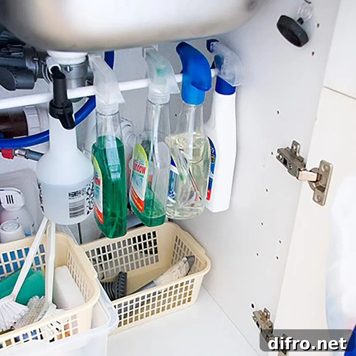 spray bottles hanging from tension rod under kitchen cabinet.