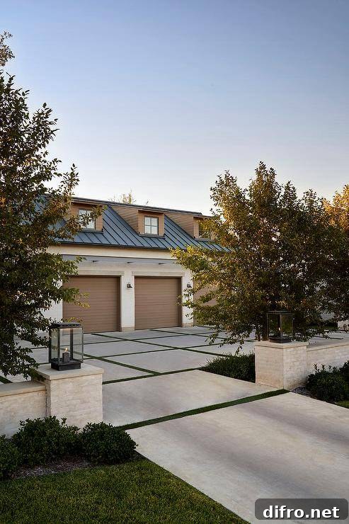 A concrete and turf driveway leads to a garage with a row of brown doors.