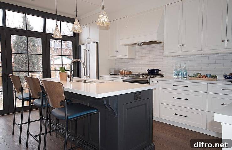 Two-tone vintage island stools at a black center island under antiqued mercury glass lights pendants.