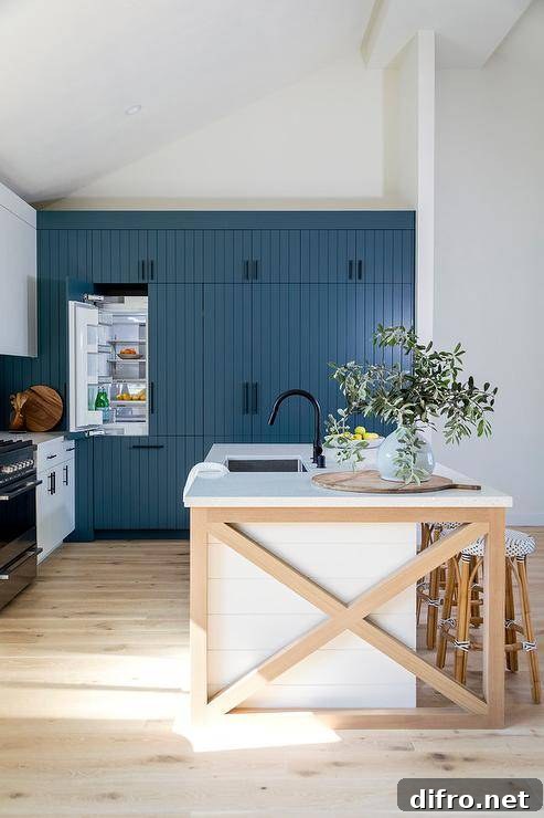 Two-toned kitchen featuring a blond wood trimmed island with backless French bistro stools.