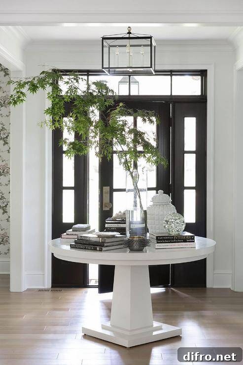 A black front door with glass panels flanked by sidelights and a transom window.