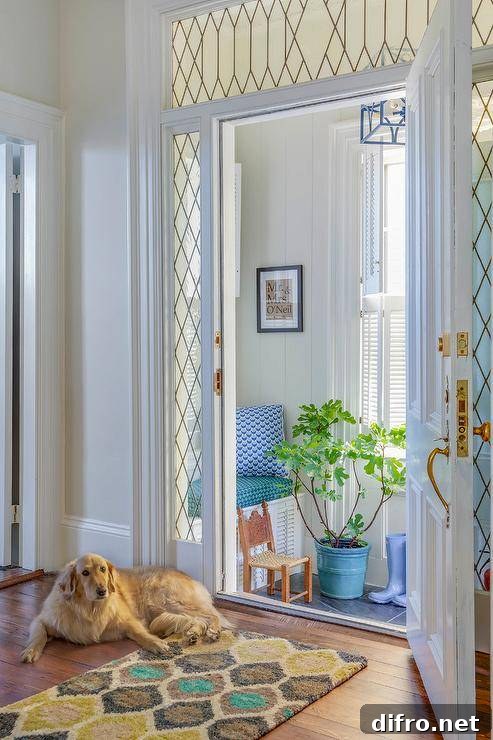 Leaded sidelights and a leaded glass transom window frame a white door.